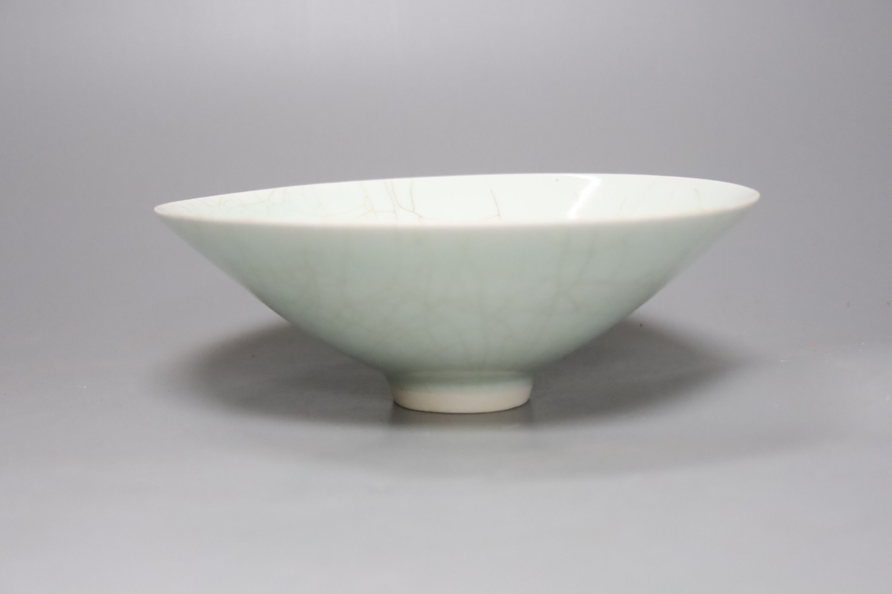 A Chinese celadon glazed vase, height 28cm, together with a crackle glaze bowl, a blue and white teabowl and saucer and a blue and white dish